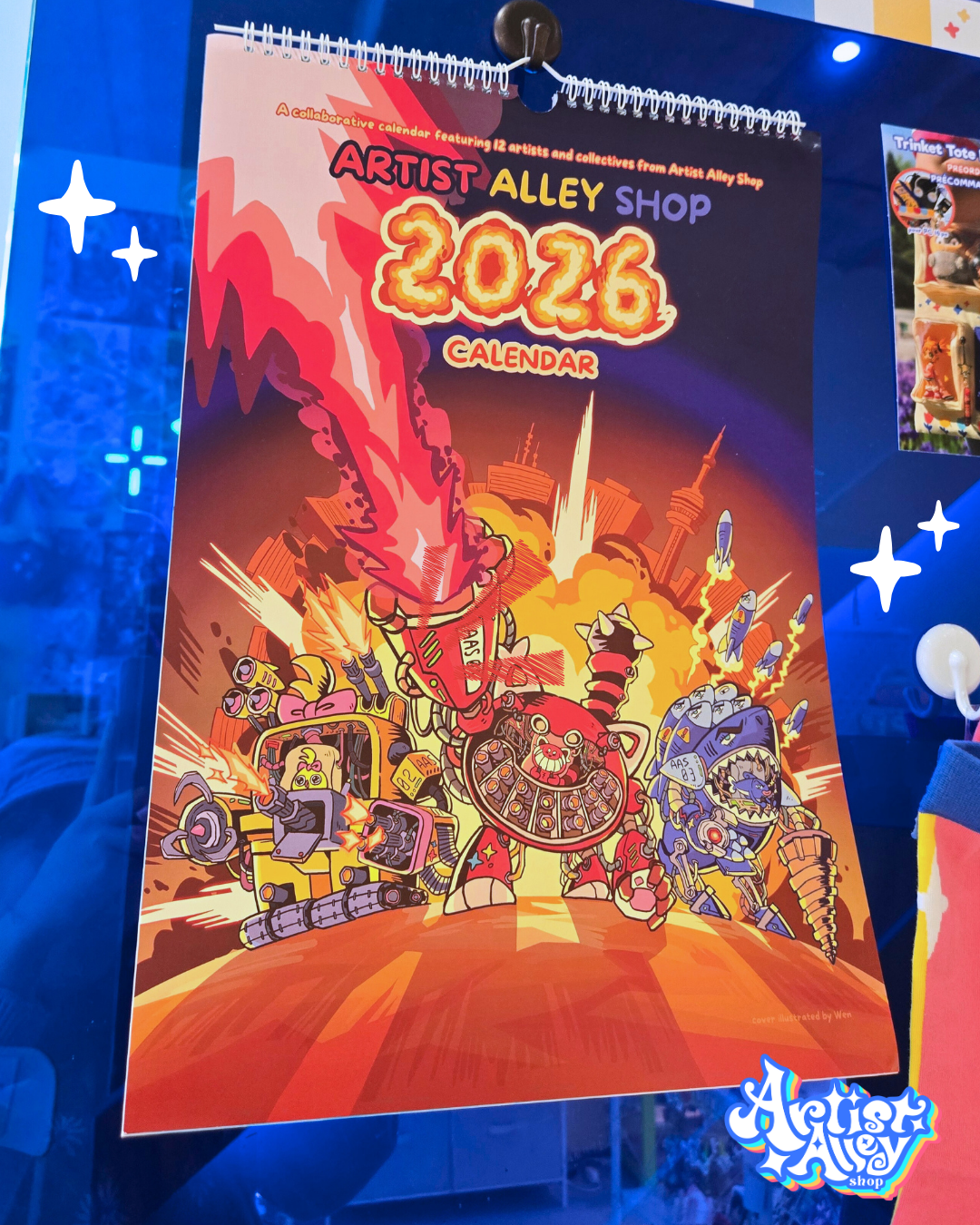 Our calendar cover features our 3 mascots: Magento, Cyano, and Yelli, operating robots.